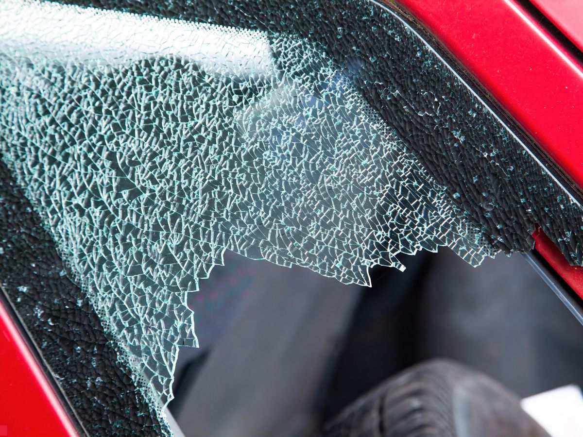 Shattered side window on a red car
