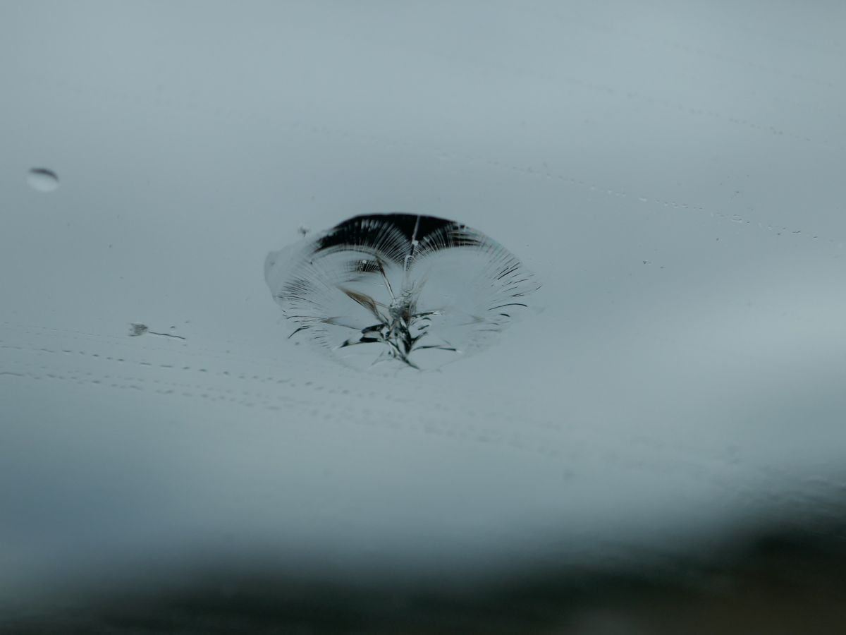 Close-up of a small stone chip in a windscreen